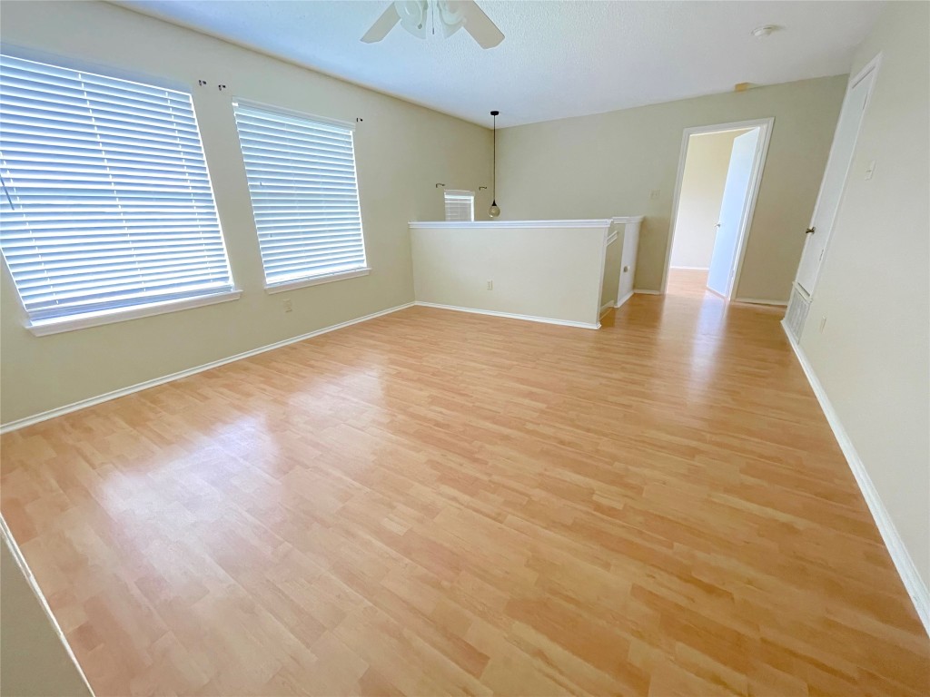 8501 Bismark Cove Austin, TX 78745 - Photo 13 of 24 a view of a room with wooden floor and a window