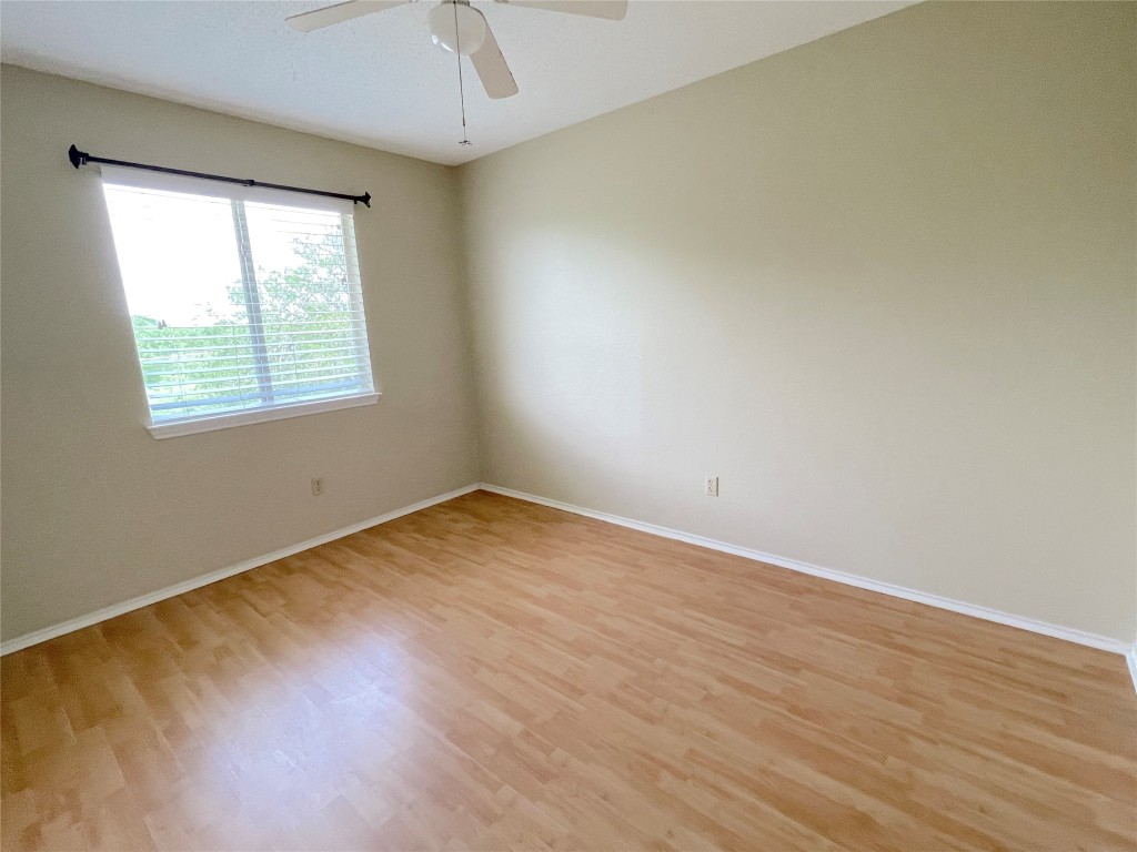 8501 Bismark Cove Austin, TX 78745 - Photo 15 of 24 an empty room with wooden floor and windows