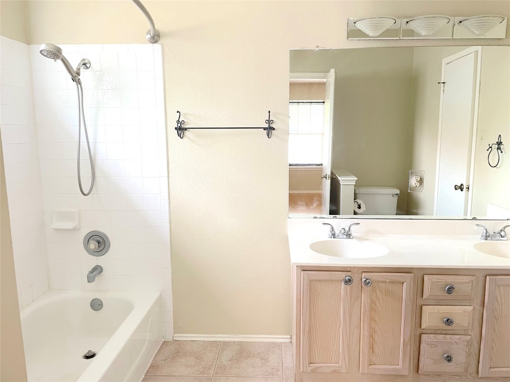 8501 Bismark Cove Austin, TX 78745 - Photo 20 of 24 a bathroom with a sink a bath tub and a shower