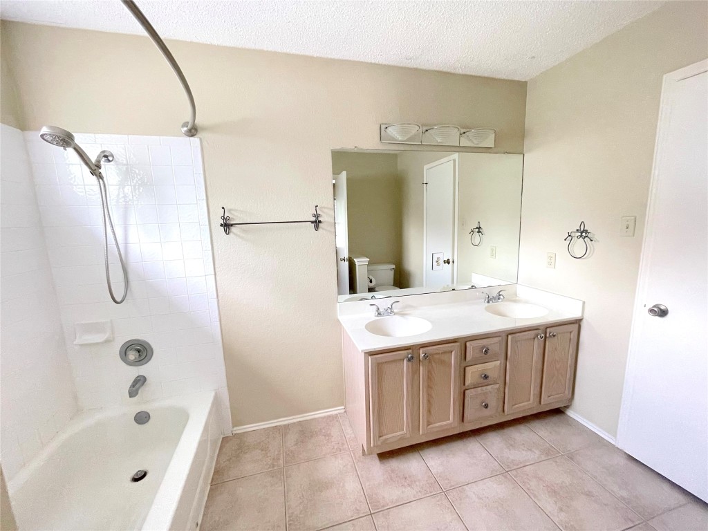 8501 Bismark Cove Austin, TX 78745 - Photo 21 of 24 a bathroom with a tub sink and mirror