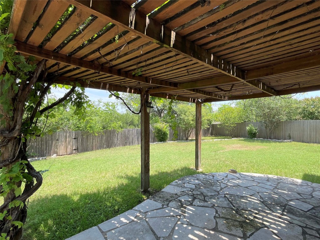 8501 Bismark Cove Austin, TX 78745 - Photo 24 of 24 a view of a backyard with table and chairs under an umbrella
