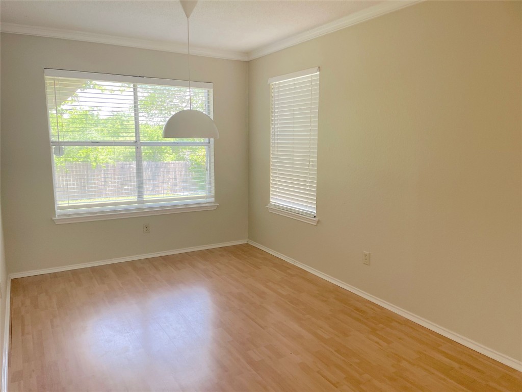8501 Bismark Cove Austin, TX 78745 - Photo 5 of 24 an empty room with wooden floor and windows