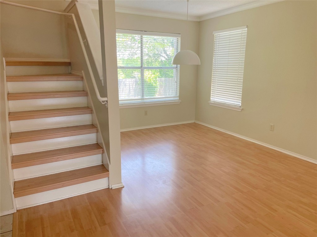 8501 Bismark Cove Austin, TX 78745 - Photo 7 of 24 a view of an empty room with wooden floor and a window