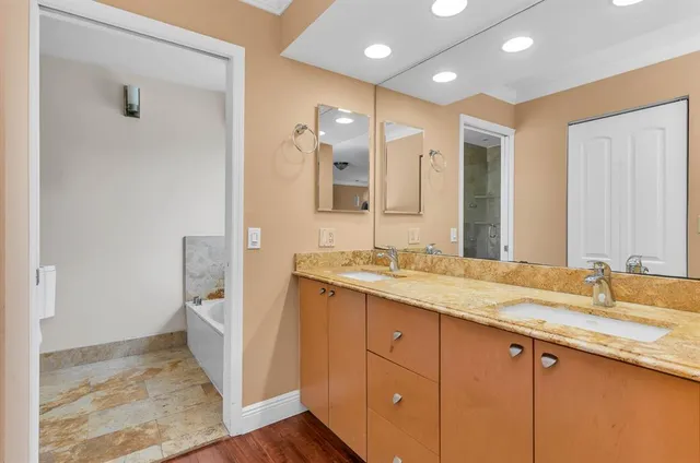 a bathroom with a granite countertop sink mirror and double