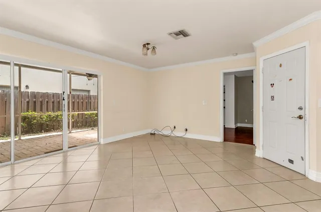a view of an empty room with glass door