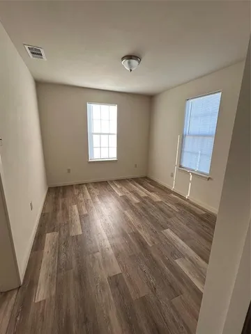 a view of room with window and hardwood floor