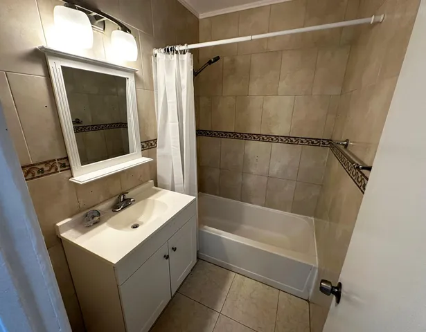 a bathroom with a sink mirror and shower