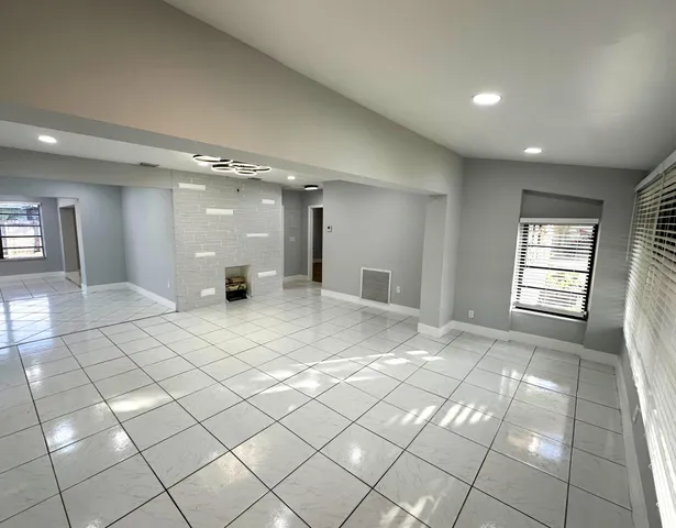 a view of an empty room and a window