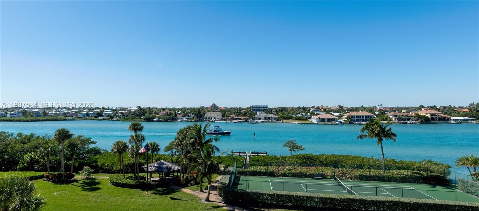 19670 South Beach Road, Unit B323 Tequesta, FL 33469 - Photo 6 of 57 a view of a lake with houses in the back