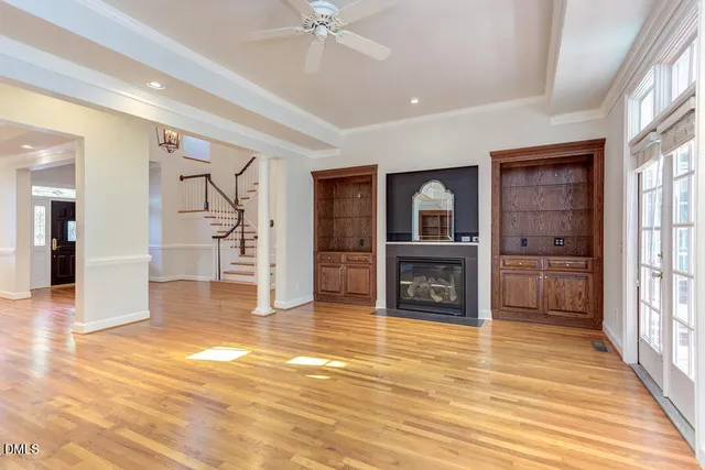 a view of an empty room with a fireplace and a window