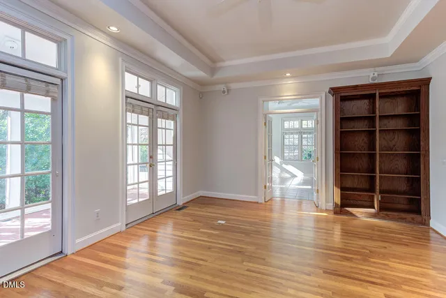 a view of a livingroom with a fireplace cabinet and windows