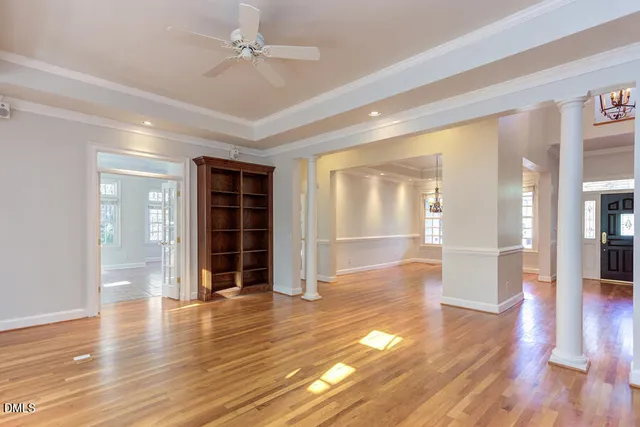 wooden floor in an empty room with a window