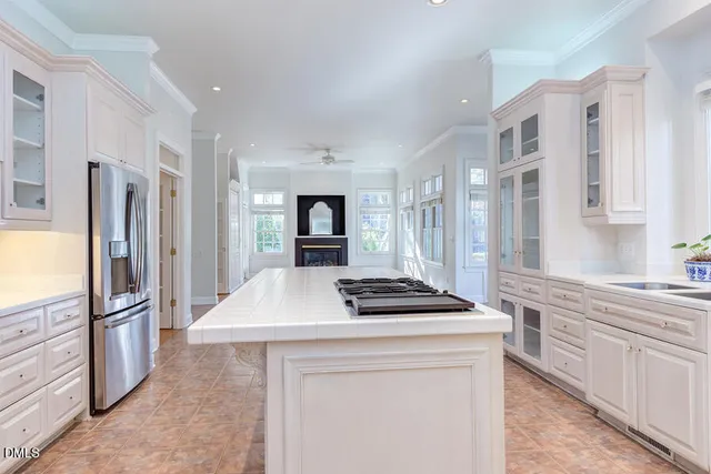 a kitchen with granite countertop a sink stainless steel appliances and window