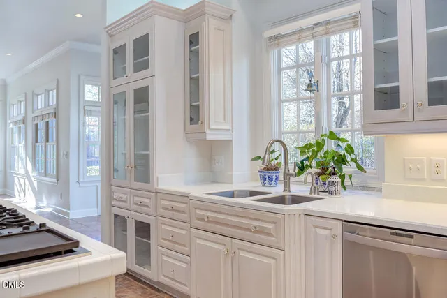 a kitchen with stainless steel appliances kitchen island a refrigerator and a stove top oven