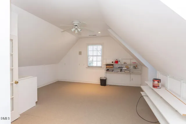 a living room with a ceiling fan and white walls
