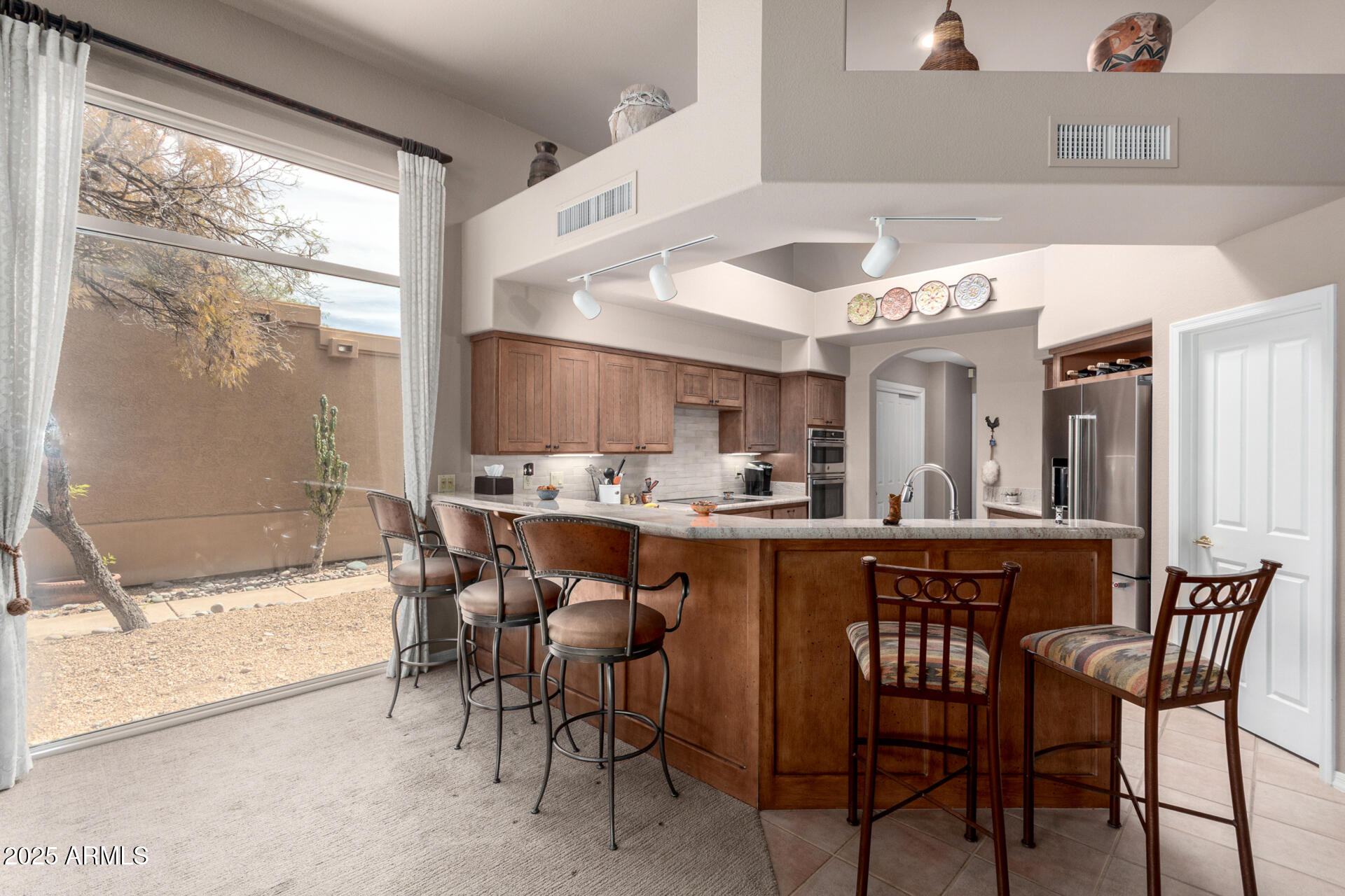 18610 Amarado Circle Rio Verde, AZ 85263 - Photo 16 of 58 a dining hall with stainless steel appliances a dining table and chairs