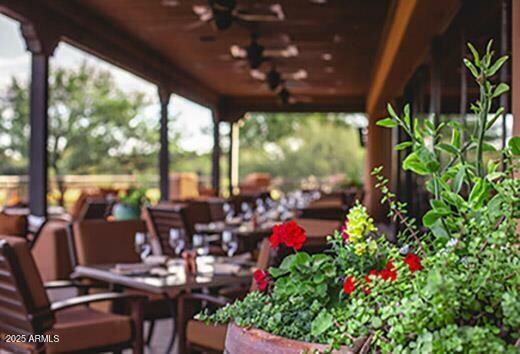 18610 Amarado Circle Rio Verde, AZ 85263 - Photo 52 of 58 a bunch of flowers sitting in a room next to a window