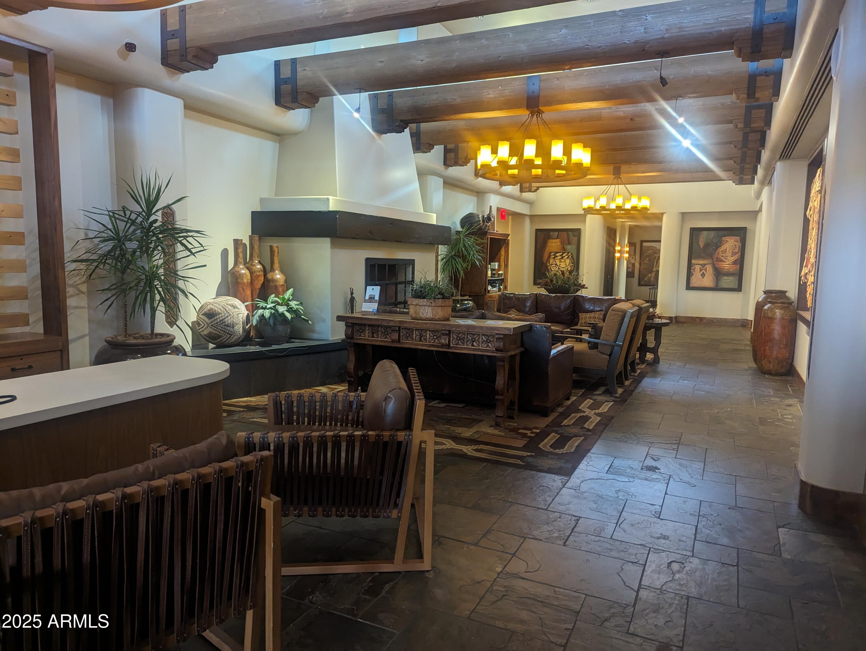 18610 Amarado Circle Rio Verde, AZ 85263 - Photo 53 of 58 a living room with furniture a chandelier and a large mirror