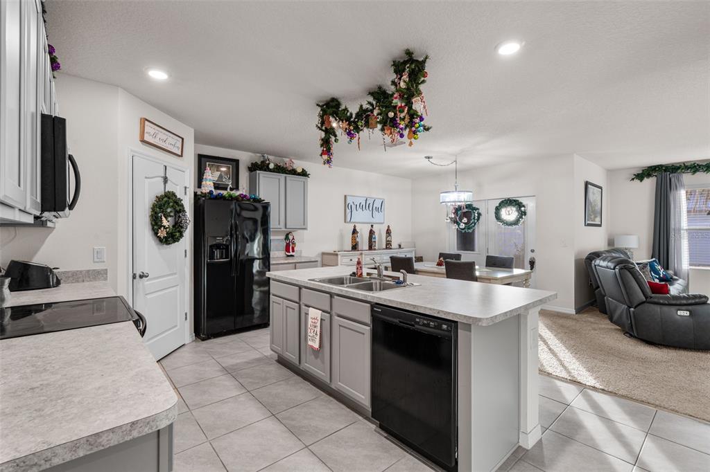 1523 White Hawk Way Groveland, FL 34736 - Photo 11 of 24 a kitchen with stainless steel appliances granite countertop a sink stove and refrigerator