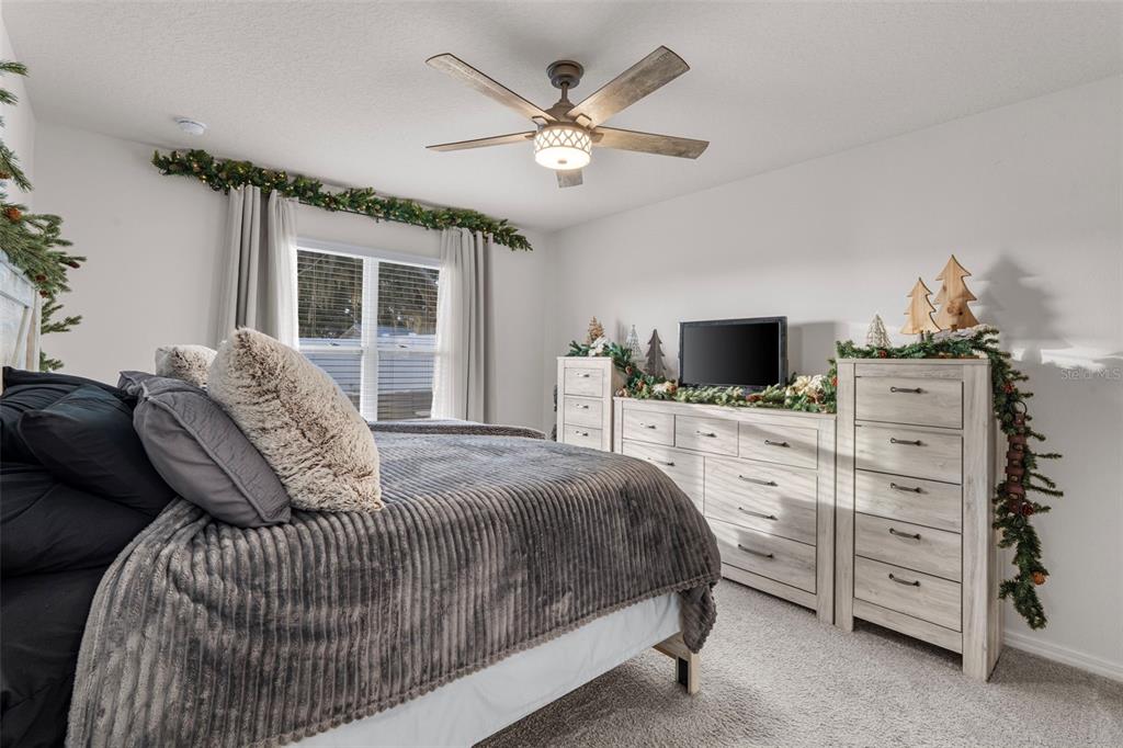 1523 White Hawk Way Groveland, FL 34736 - Photo 18 of 24 a bedroom with a bed and a flat screen tv