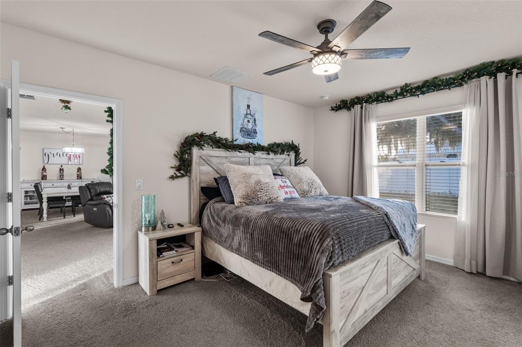 1523 White Hawk Way Groveland, FL 34736 - Photo 19 of 24 a spacious bedroom with a bed and a large window