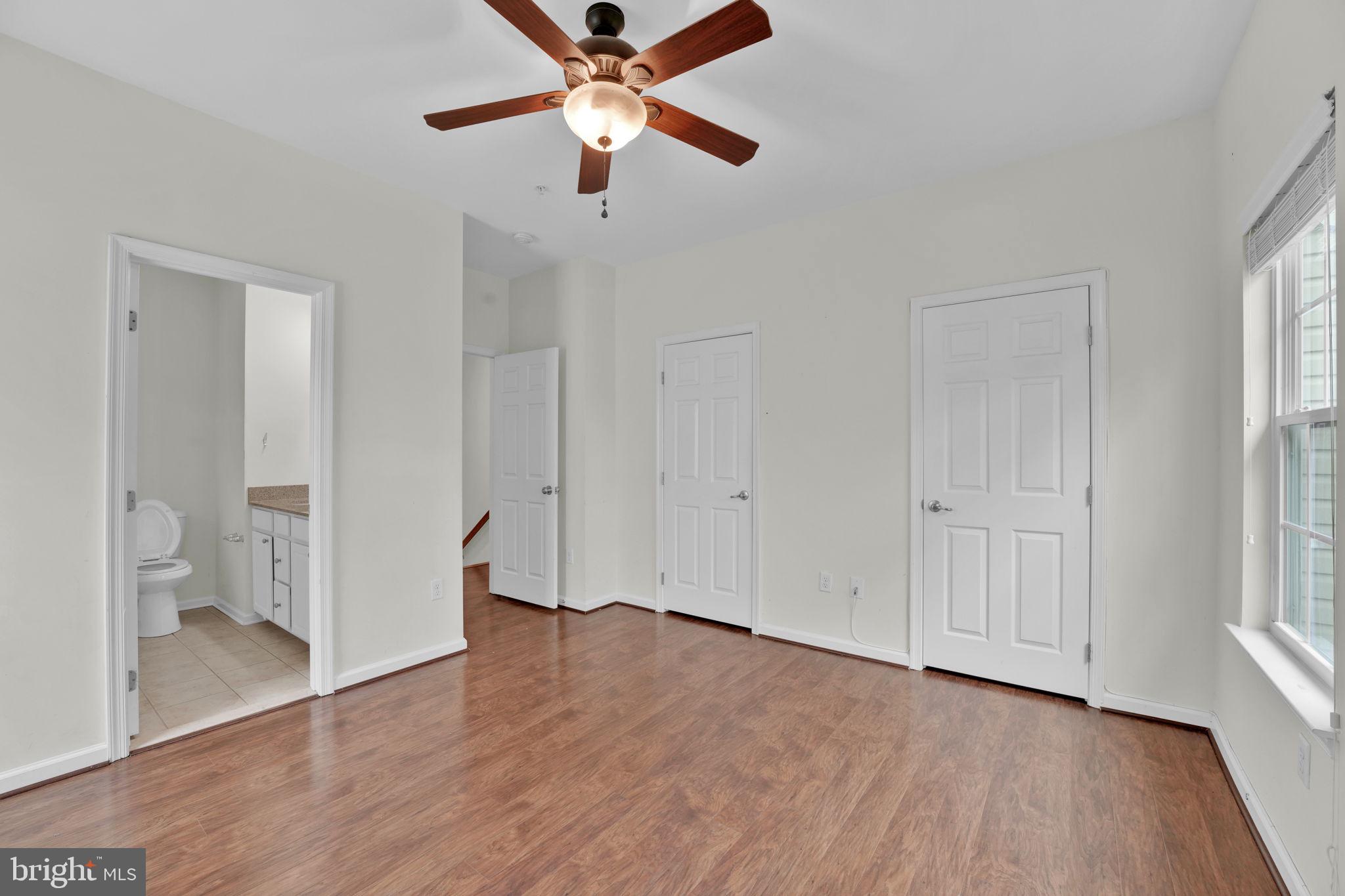 7138 Station House Road Elkridge, MD 21075 - Photo 14 of 42 wooden floor in an empty room with a bathroom