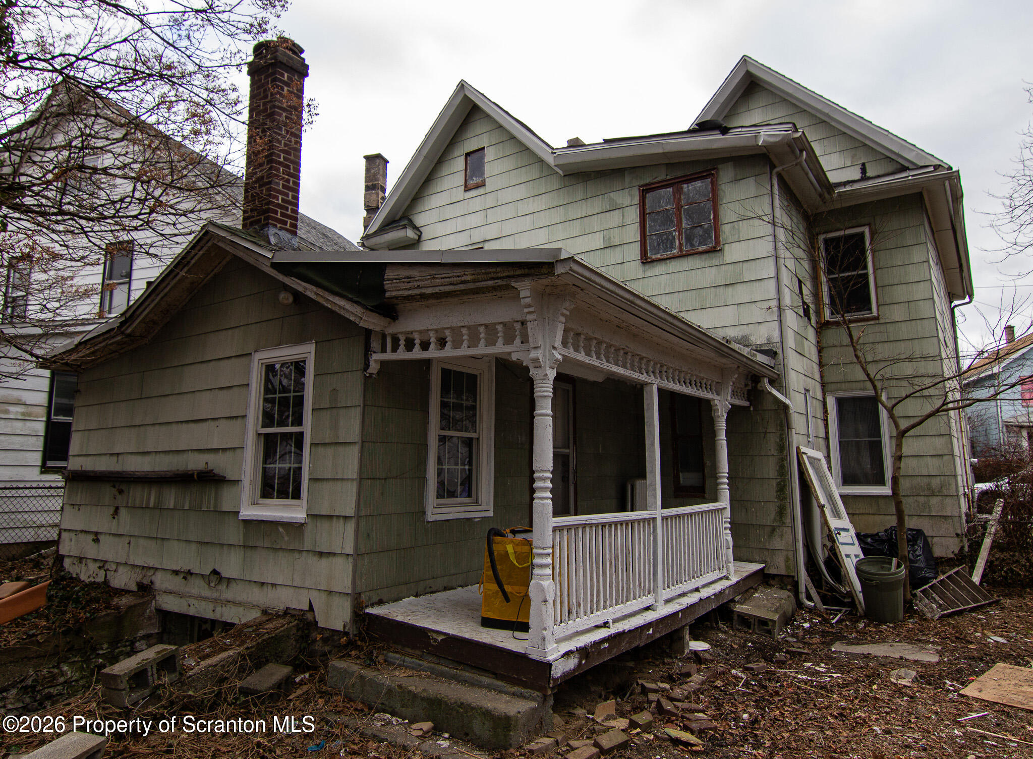 214 William Street Scranton, PA 18508 - Photo 5 of 33 a view of house with a large window and wooden fence
