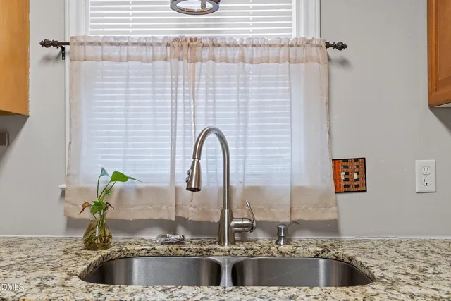 a kitchen with stainless steel appliances granite countertop a stove microwave and sink