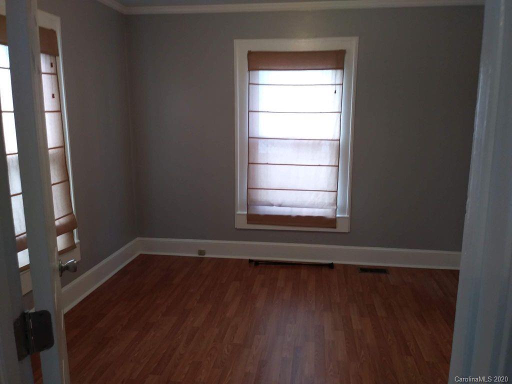 1002 South Ridge Avenue Kannapolis, NC 28083 - Photo 3 of 9 a view of an empty room with wooden floor and a window