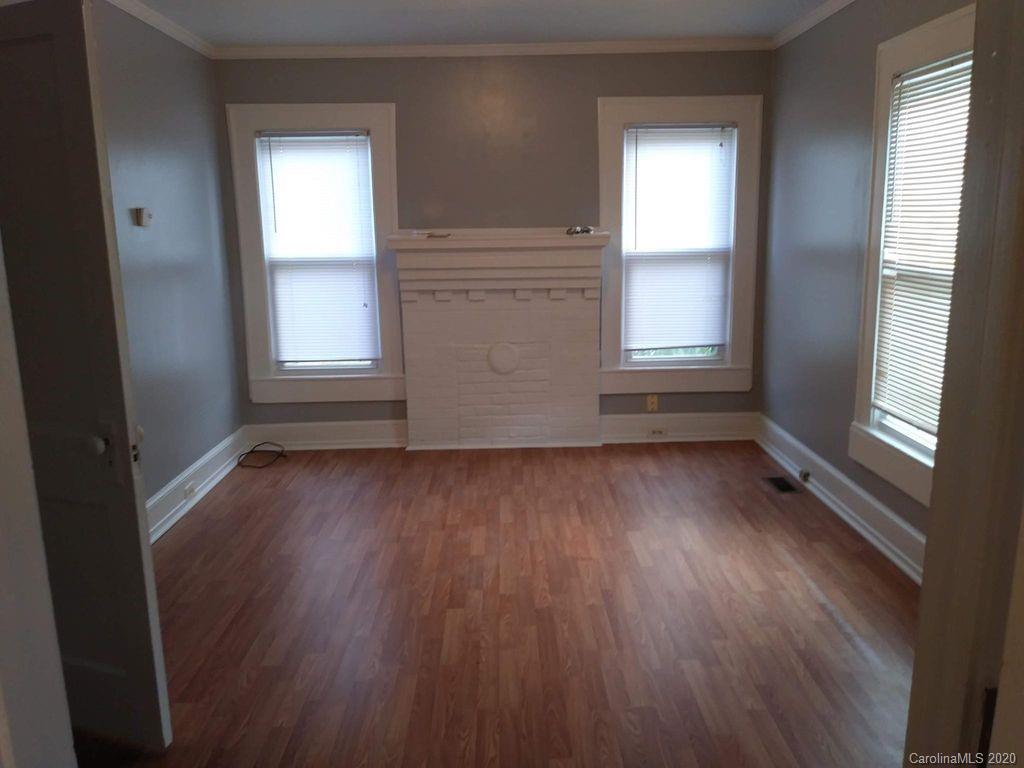 1002 South Ridge Avenue Kannapolis, NC 28083 - Photo 4 of 9 an empty room with wooden floor and windows