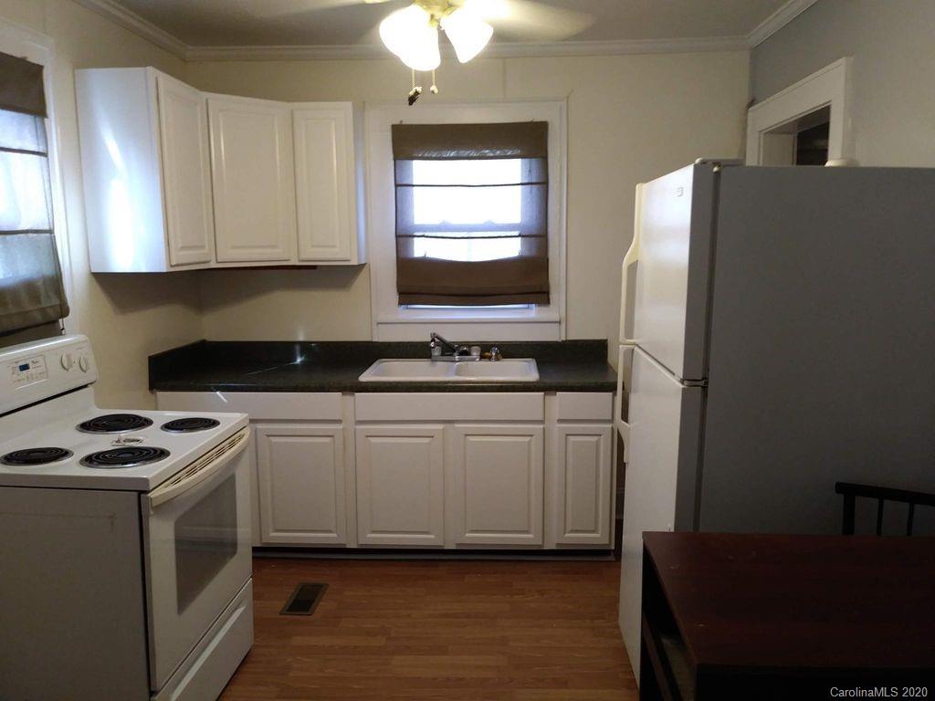 1002 South Ridge Avenue Kannapolis, NC 28083 - Photo 6 of 9 a kitchen with a refrigerator stove and sink