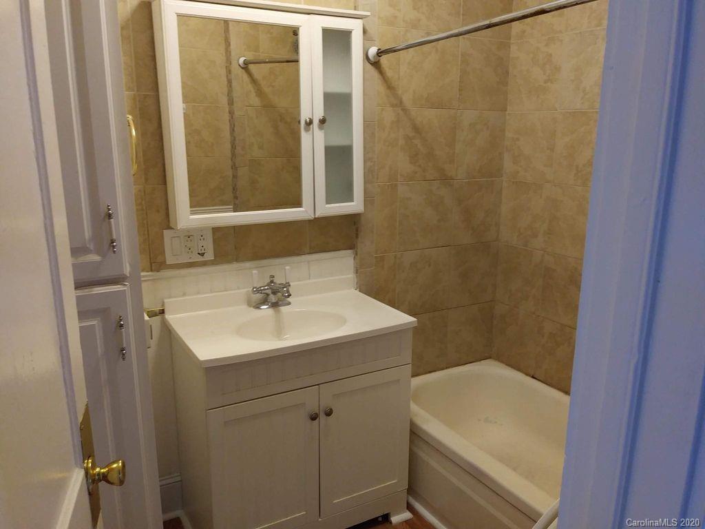 1002 South Ridge Avenue Kannapolis, NC 28083 - Photo 7 of 9 a bathroom with a sink a toilet and shower