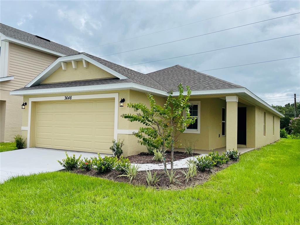 7625 Bent Tree Loop St. Cloud, FL 34773 - Photo 1 of 16 a front view of house with a garden