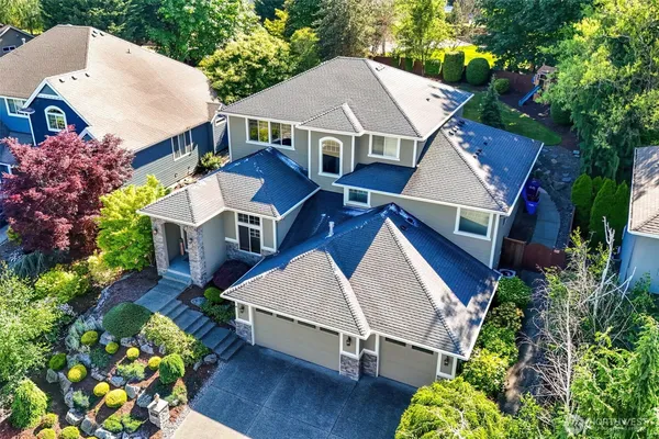 an aerial view of a house with a yard and sitting area