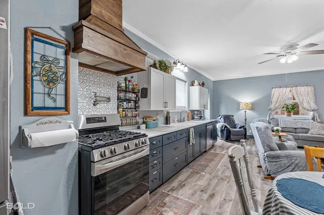 a living room with stainless steel appliances kitchen island granite countertop furniture and a kitchen view