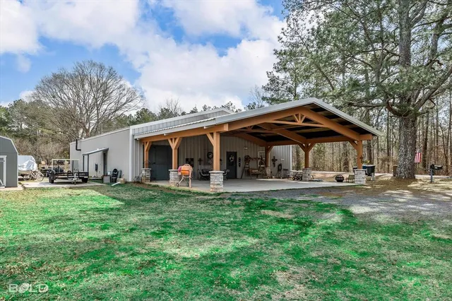 a view of a house with backyard and sitting area