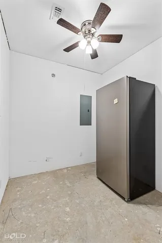 a bedroom with a bed and a ceiling fan