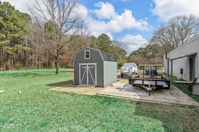 a park view with a bench under large trees