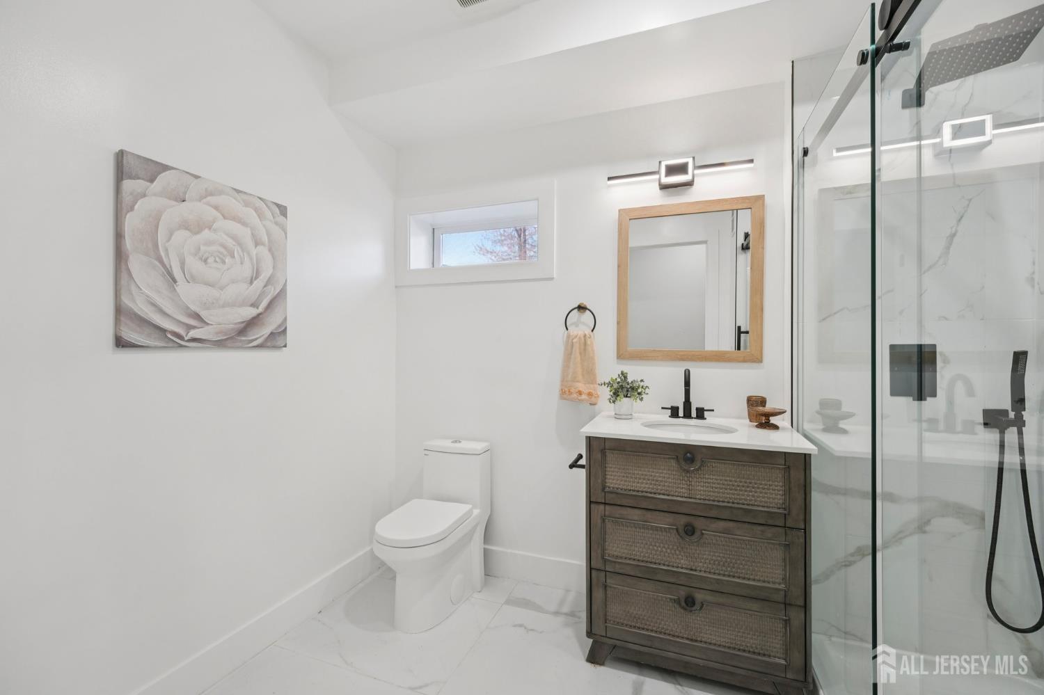 75 Jefferson Boulevard Edison, NJ 08817 - Photo 49 of 75 a bathroom with a toilet sink and mirror