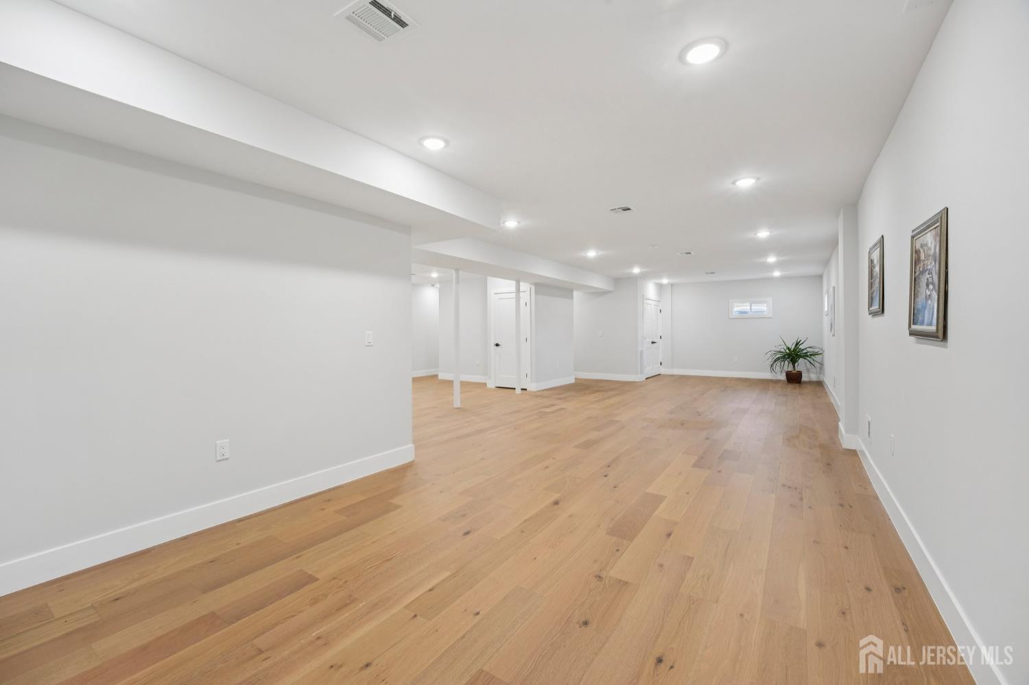 75 Jefferson Boulevard Edison, NJ 08817 - Photo 53 of 75 a view of big room with wooden floor and windows