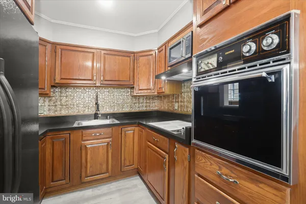a kitchen with stainless steel appliances granite countertop a sink stove and cabinets