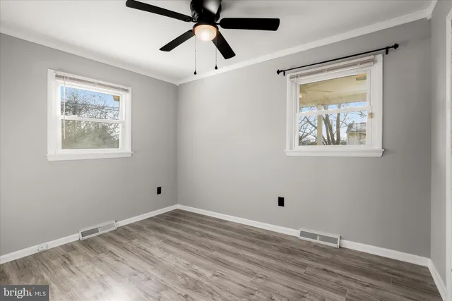 a view of room with window and wooden floor