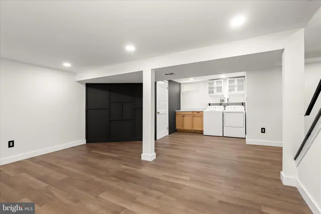 a view of a kitchen with a sink and a refrigerator
