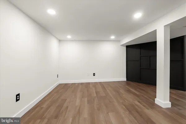 an empty room with wooden floor