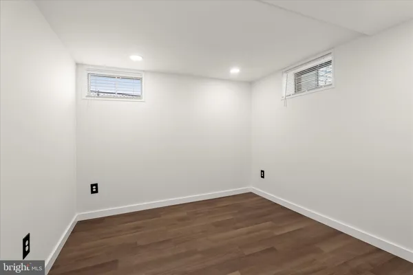 a view of a room with wooden floor and window