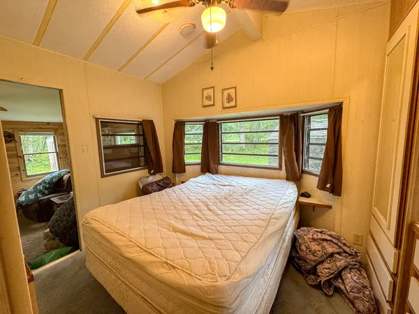 a bedroom with a bed and a chandelier