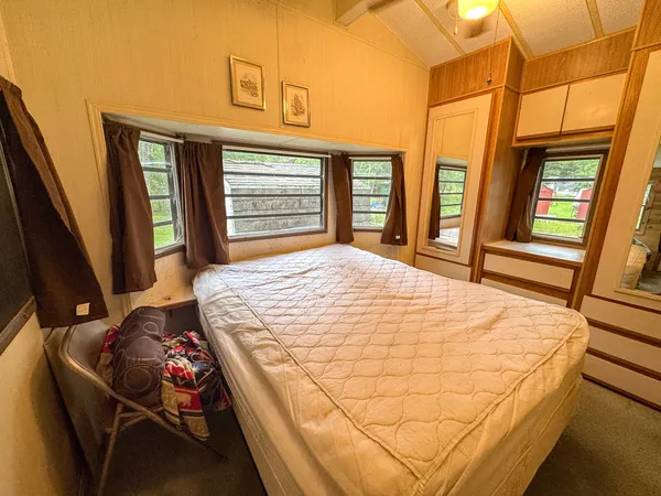 a bed sitting in a bedroom next to a window