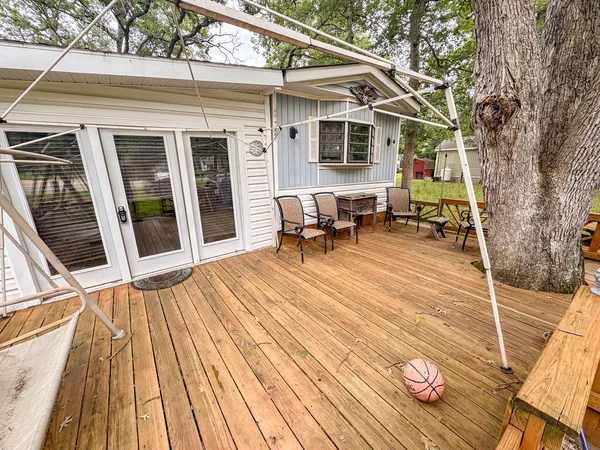 a backyard of a house with table and chairs