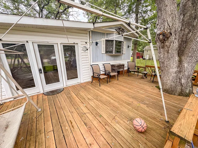 a backyard of a house with table and chairs