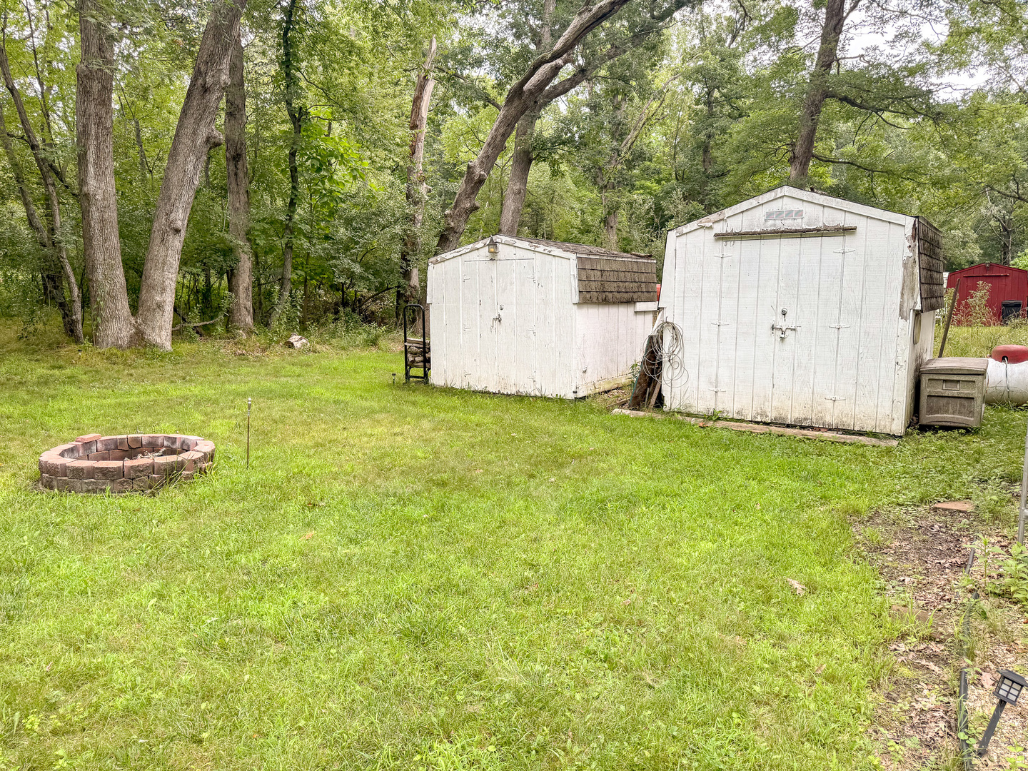 2-24 Woodhaven Sublette, IL 61367 - Photo 5 of 17 a backyard of a house with table and chairs and a large tree